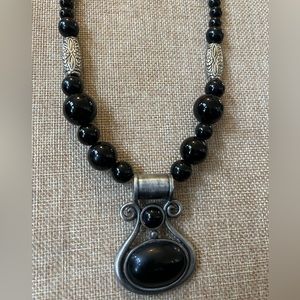 Brooding Silver Tone and Black Stone Pendant